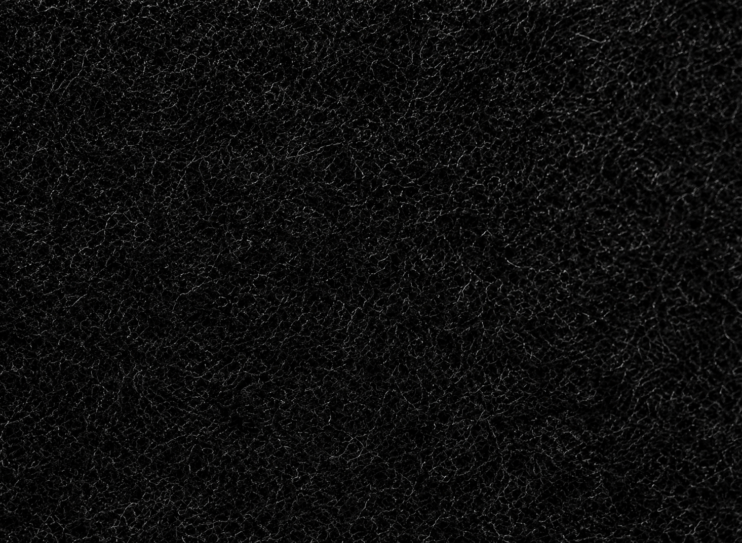 Close-up black textured wall panel surface with intricate dark fibre detailing, creating a premium modern decorative finish for luxury interior wall designs.
