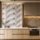 Modern luxury kitchen featuring a white marble accent wall with gold veining, warm wooden cabinetry, soft ambient lighting, and elegant contemporary interior styling.