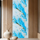 Modern luxury interior featuring a sky blue marble accent wall with elegant gold veining, warm wooden slat panels, sculptural decor pieces, and minimalist contemporary styling.