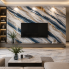 Luxury modern living room featuring a blue, white, and gold UV marble sheet TV wall with elegant lighting, glossy marble flooring, and premium contemporary interior décor.