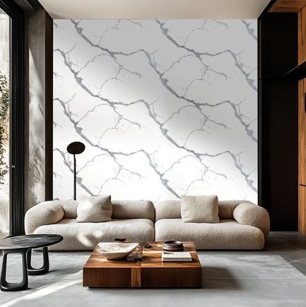 white-carrara-marble-wall-sticker Modern luxury living room featuring a white marble wall panel with bold grey veining, paired with a curved beige sofa, wooden accents, and contemporary minimalist interior design.